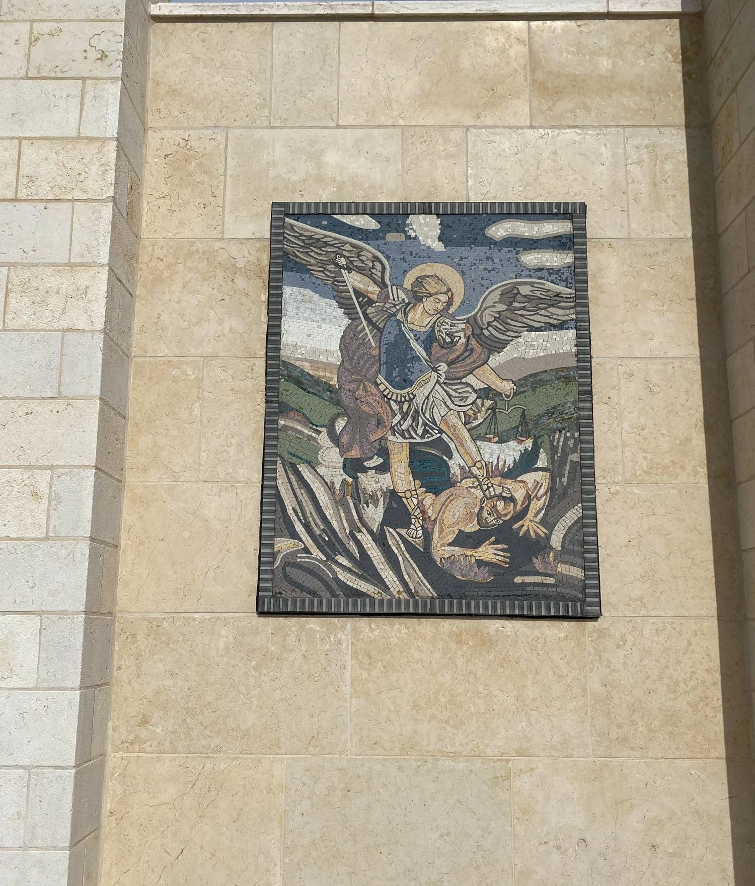Mosaic of Saint Michael on the limestone façade of our shop
