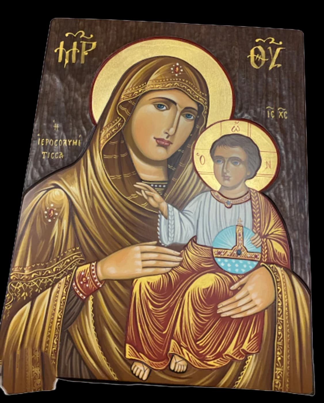 Hand-painted icon of the Virgin Mary in a golden mantle holding the Christ Child